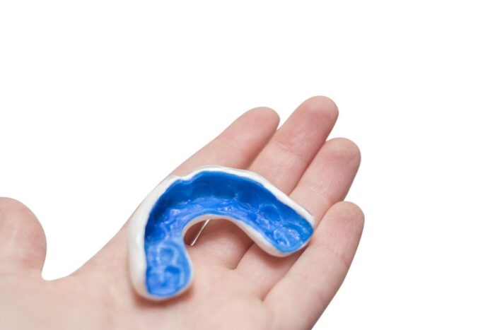 White custom sport mouthguard on a hand custom mouthguard dentist in Owings Mills Maryland