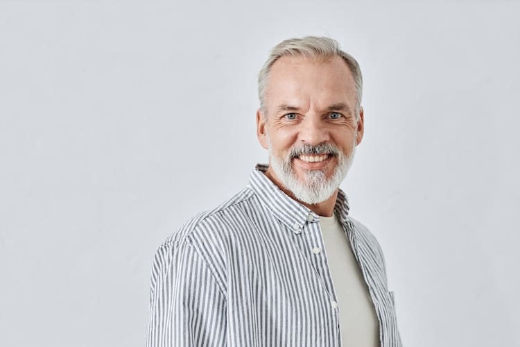 Stylish Senior Man with Toothy Smile Portrait Medium close up shot of bearded senior man with toothy smile looking at camera isolated on white background